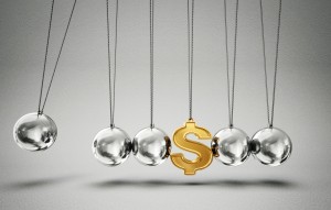 conceptual balancing balls with dollar sign isolated on a grey